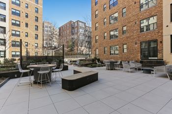 Landscaped courtyard with grills and lounge areas